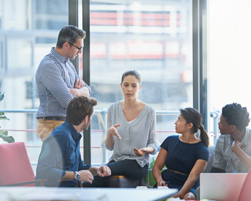 People in creative meeting, brainstorming and teamwork in project management at business agency. Communication, collaboration and group strategy, men and women talk about design process at startup.